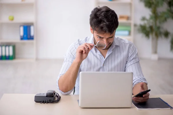 stock image Young employee sitting at workplace