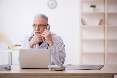 Teletıp konseptinde yaşlı bir doktor.