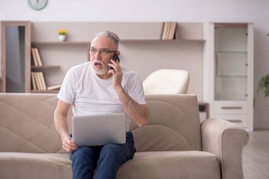 Old man sitting at home during pandemic