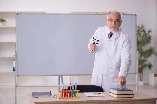 Old chemistry teacher in the classroom