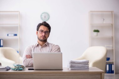 Young accountant sitting at workplace