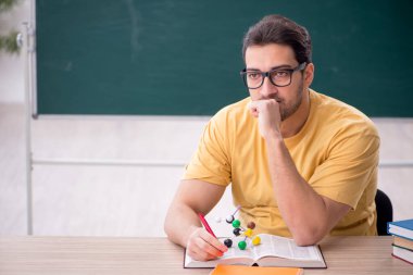 Young student physicist sitting in the classroom