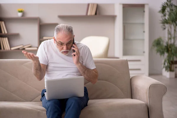 Old man sitting at home during pandemic