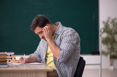 Young physicist student in the classroom