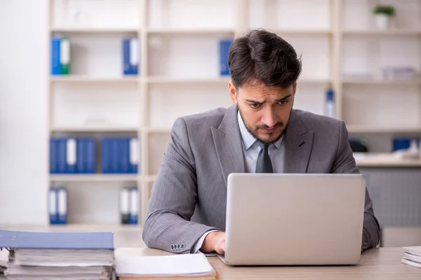 stock image Young employee working at workplace