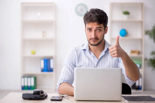 stock image Young employee sitting at workplace