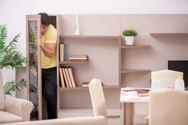 stock image Young man cleaning the house