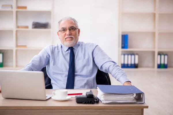 stock image Old employee working at workplace