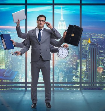 The young businessman in multitasking concept clipart