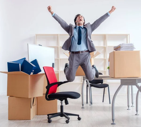 stock image The young man employee with boxes in the office