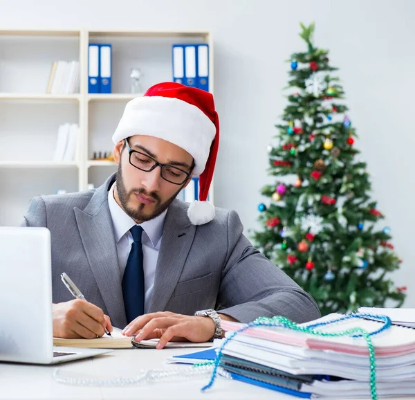 stock image The young businessman celebrating christmas in the office