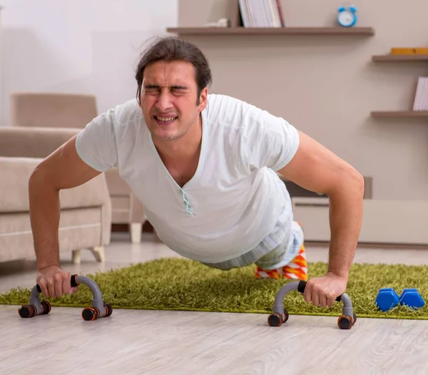 Young Man Doing Sport Exercises Indoors — Stock Photo, Image