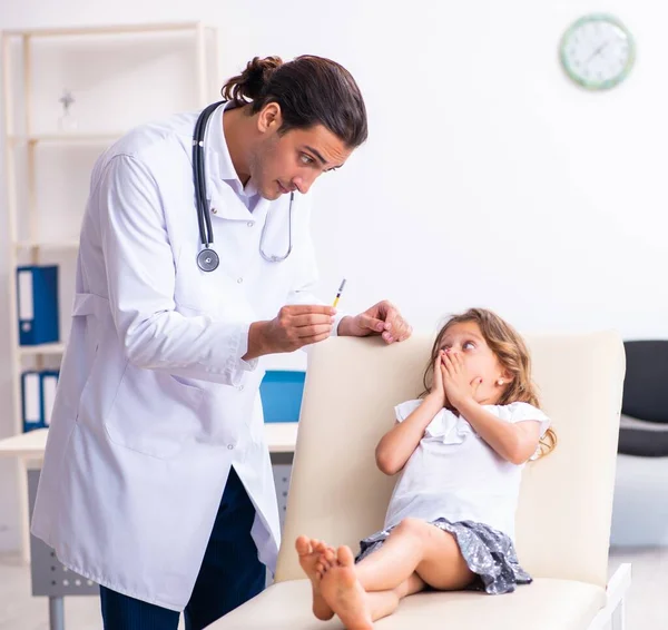 stock image The young doctor pediatrician with small girl