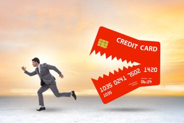 Businessman in the credit card debt concept