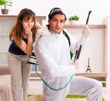 The young professional contractor doing pest control at flat clipart