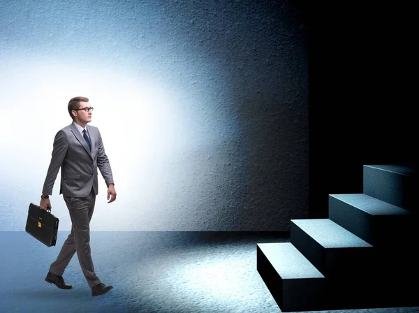 The businessman walking towards keyhole in challenge concept