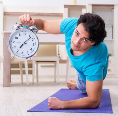 The young handsome man doing morning exercises