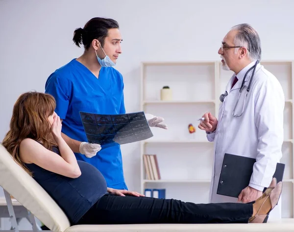 Two Doctors Examining Young Woman — Stock Photo, Image