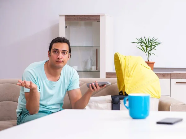 stock image Young man parent looking after newborn at home