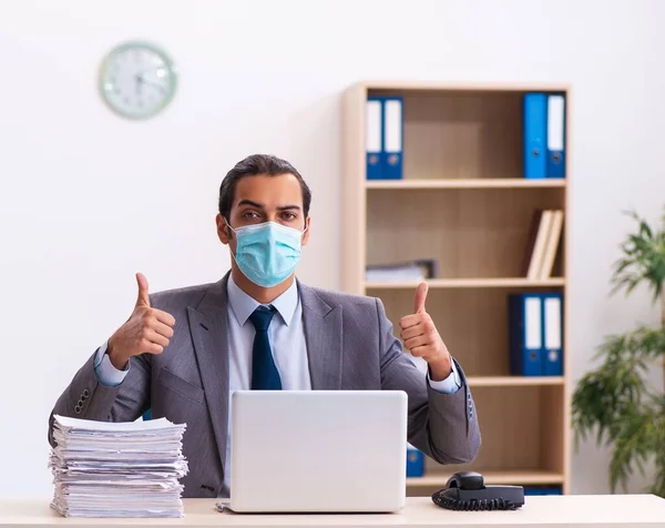 Young employee wearing mask during pandemic
