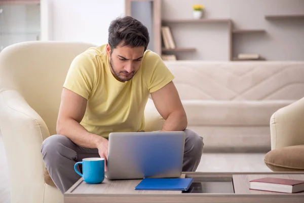 stock image Young male student working from home during pandemic