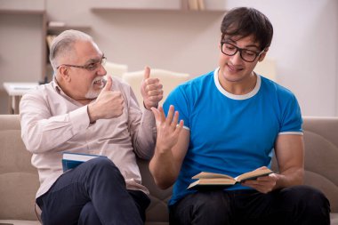 Young student and his grandfather at home