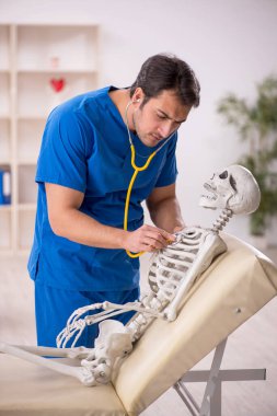 Young doctor and skeleton patient at the hospital