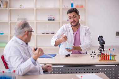 Two chemists working at the lab