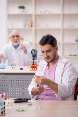 Two chemists working at the lab