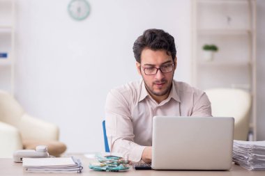 Young accountant sitting at workplace