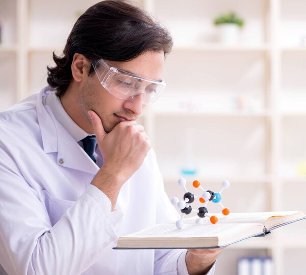 The young male scientist working in the lab