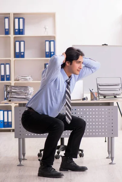 Young Handsome Male Employee Doing Exercises Office — Stockfoto