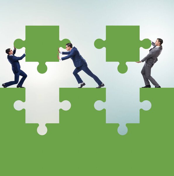 Businessman in the teamwork concept with jigsaw puzzle