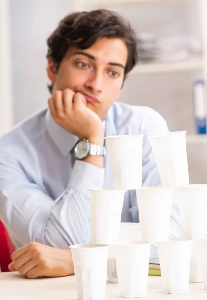Young Employee Building Pyramid Plastic Cups — Stock Photo, Image