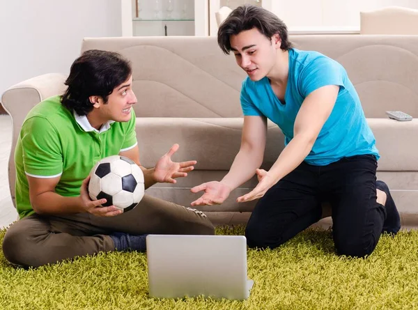 stock image The friends watching football at home