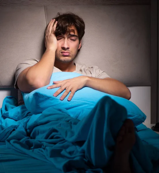 stock image The tired exhausted man sleeping in his bed