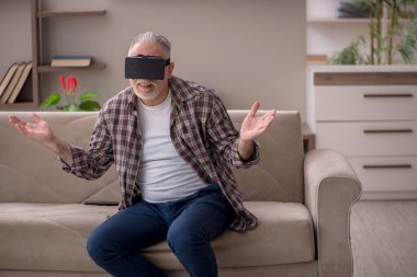 Old man enjoying virtual glasses at home