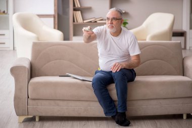 Old man sitting at home during pandemic
