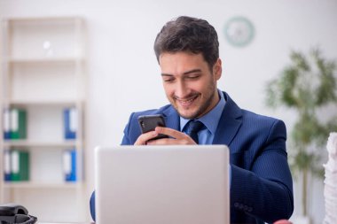 Genç bir çalışan ve ofiste çok fazla iş var.