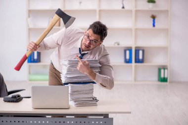 Young employee and too much work at workplace