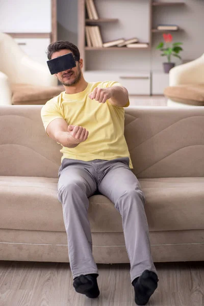 stock image Young male student enjoying virtual glasses at home