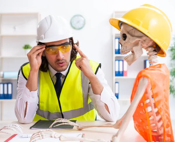 Funny construction meeting with boss and skeletons