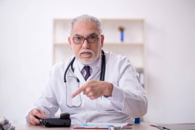 Teletıp konseptinde yaşlı bir doktor.