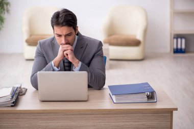 Genç çalışan işyerinde oturuyor.