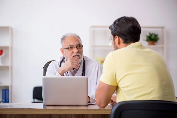 Young Patient Visiting Old Male Doctor — Stock Photo, Image