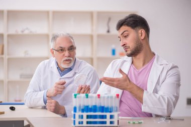 Two chemists working at the lab