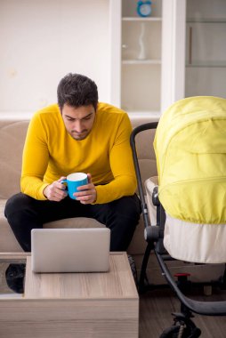 Young contractor looking after baby at home