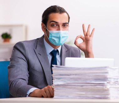 Salgın sırasında maske takan genç bir çalışan