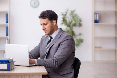 Genç çalışan işyerinde oturuyor.