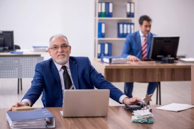 Two male employees with star award in the office